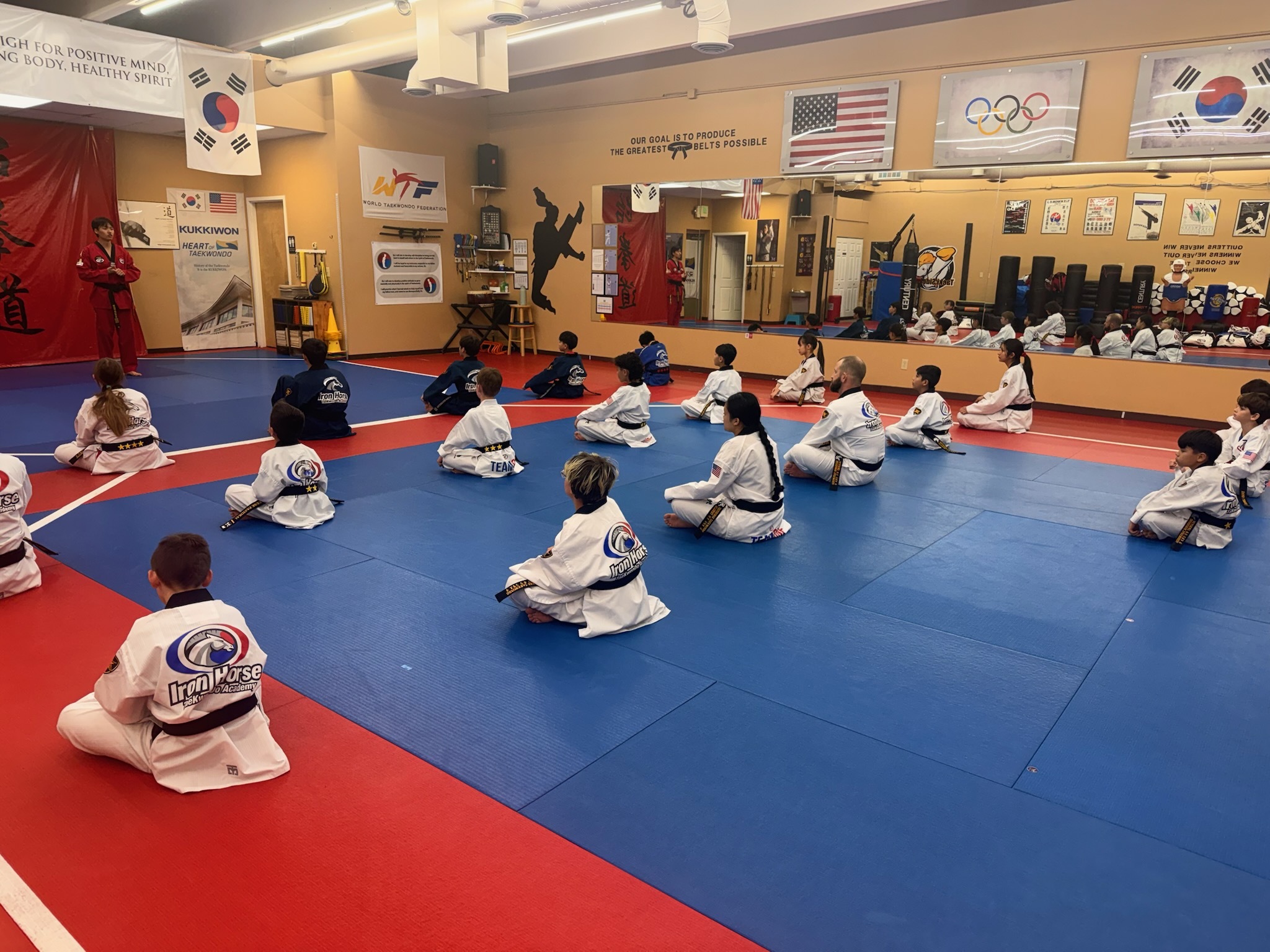 Students seated in meditation during group Taekwondo class